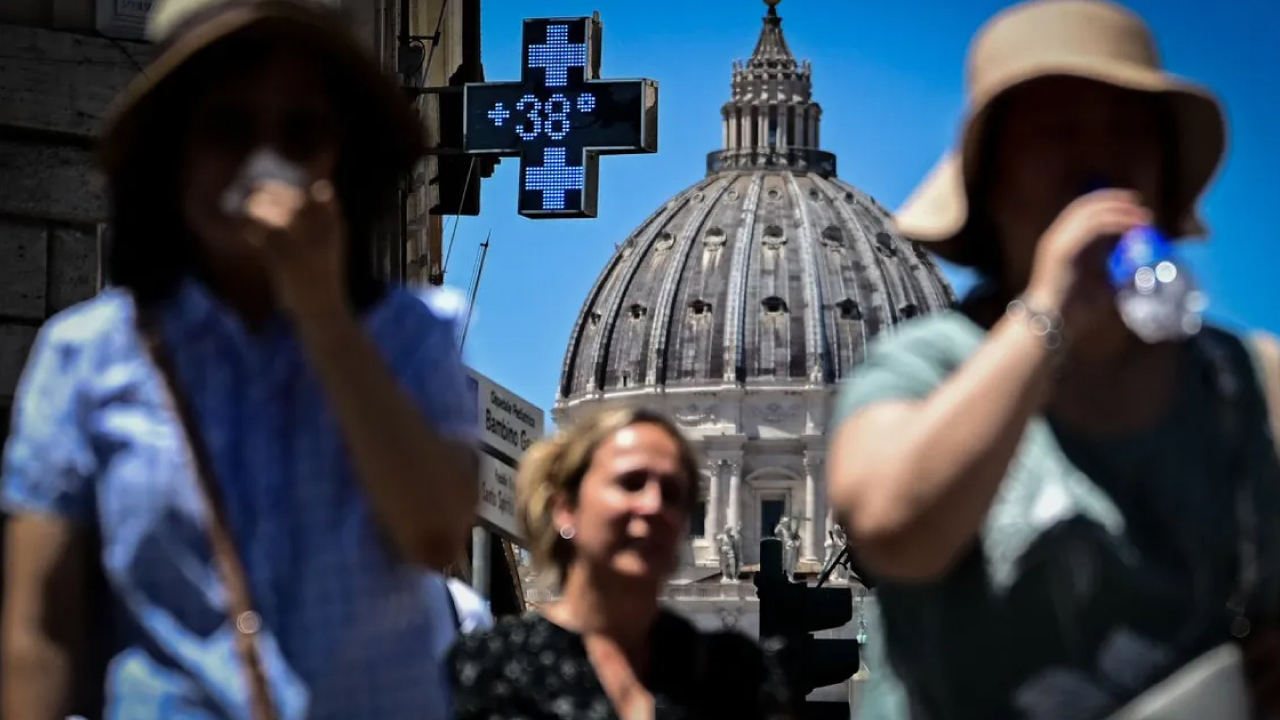 Personas refrescándose en una fuente en Madrid durante la ola de calor de julio de 2025.